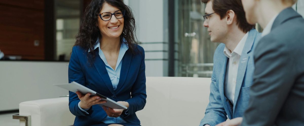 Professionals discussing business strategy in a corporate office setting.